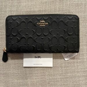 COACH signature leather wallet.